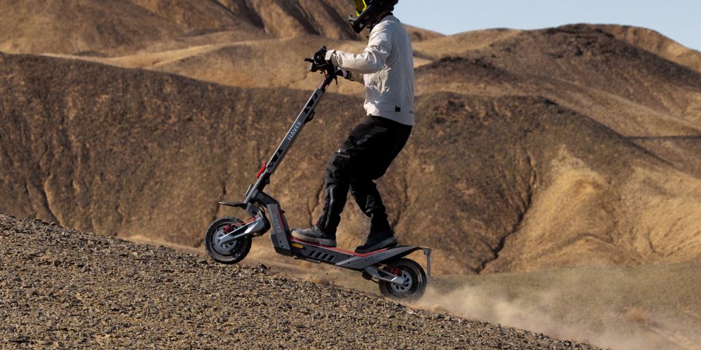 man riding up incline on Navee XT5 Pro electric scooter