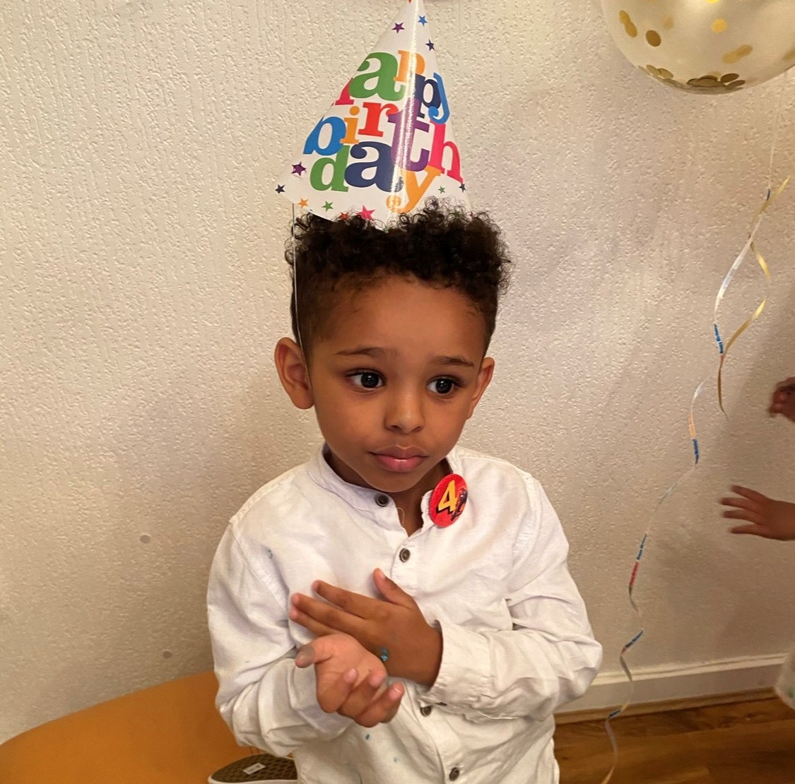 Fareed Amir, a five-year-old boy, wearing a birthday hat.