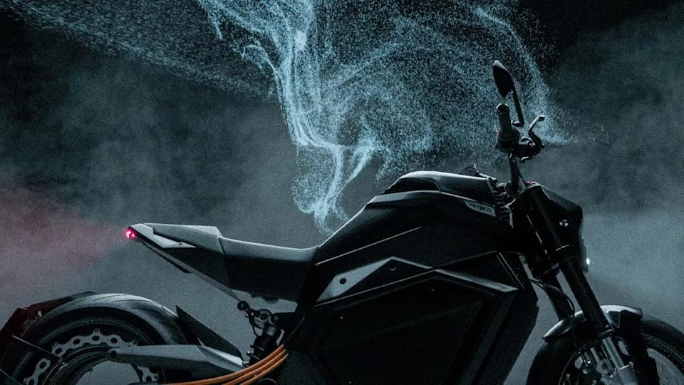 Black electric motorcycle with orange cables and blue smoke effect in the background.