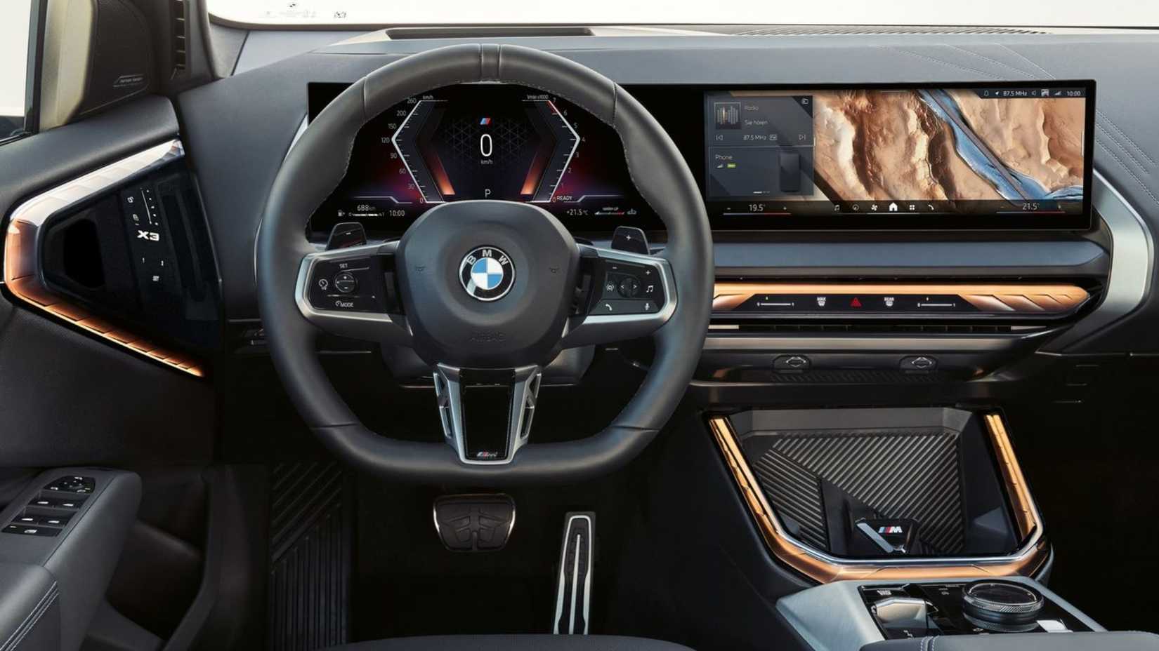 Shot of the steering wheel and dashboard inside the cabin of a 2025 BMW X3.