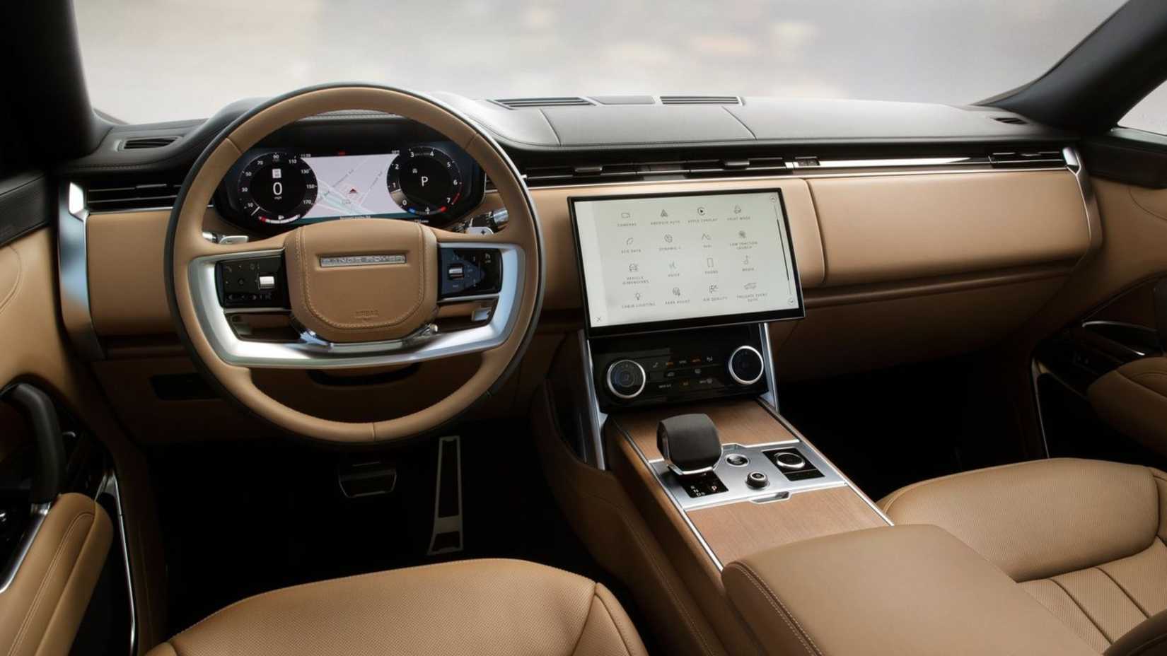 Stot of the steering wheel and dashboard inside the cabin of a 2022 Land Rover Range Rover.