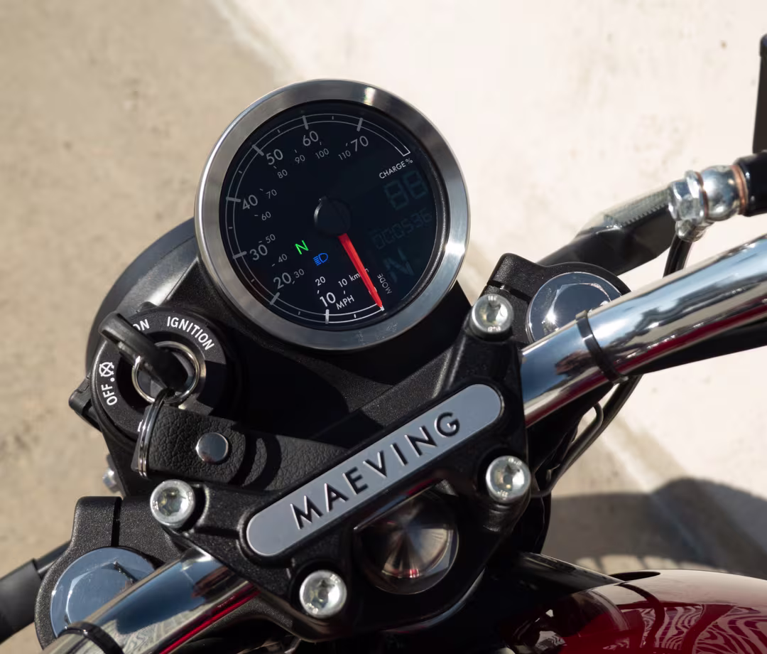 Red Maeving RM2 electric motorcycle dashboard detail, part of Men's Journal tested motorcycle reviews.