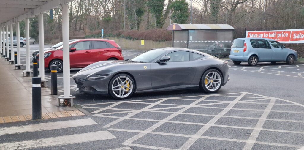 [Ferrari Roma] in a Sainsbury's parking lot.