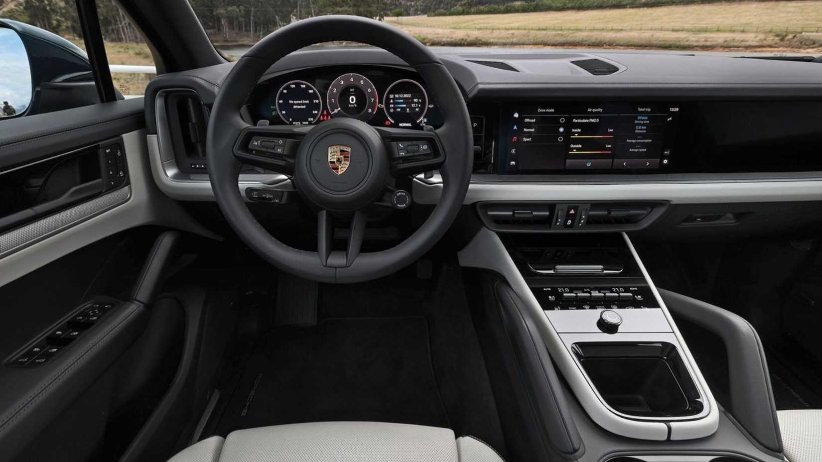 Shot of the steering wheel and dashboard inside the cabin of a 2024 Porsche Cayenne.