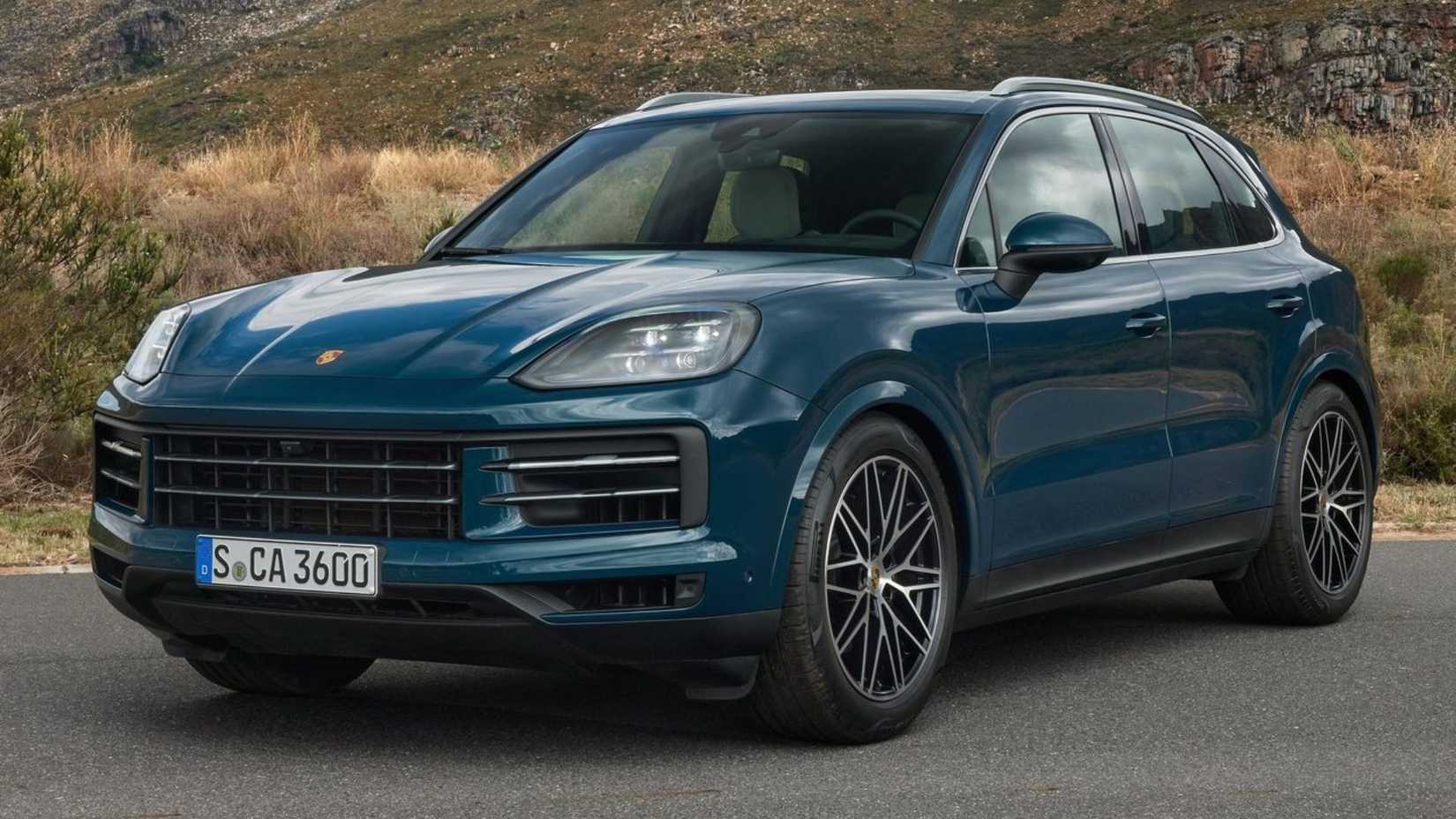 Static front 3/4 shot of a blue 2024 Porsche Cayenne.