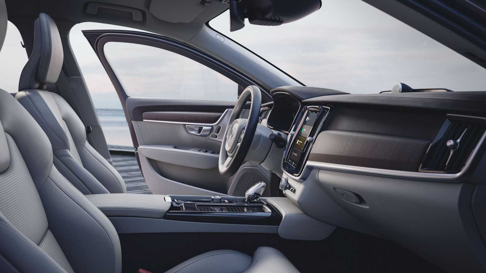 Shot inside the cabin of Volvo S90 Recharge T8 AWD, showing the front seats and dashboard.