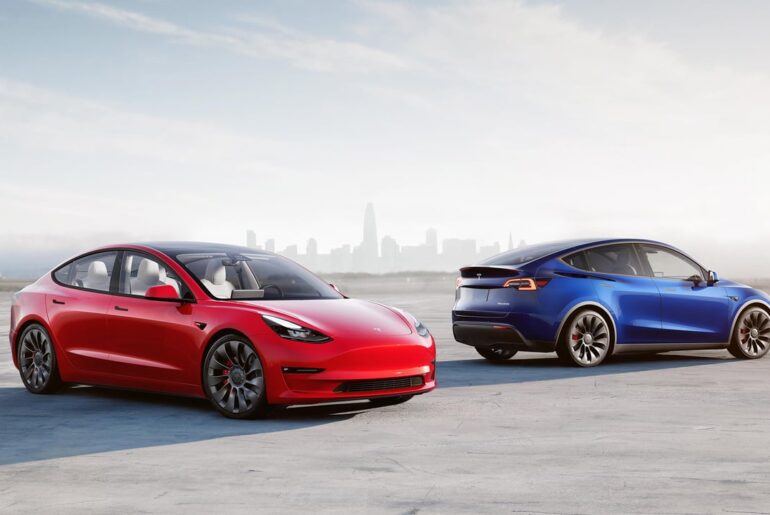 Two Teslas parked near each other outside.