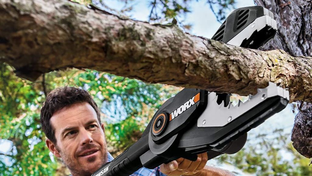 man using Worx JawSaw chainsaw on tree branch