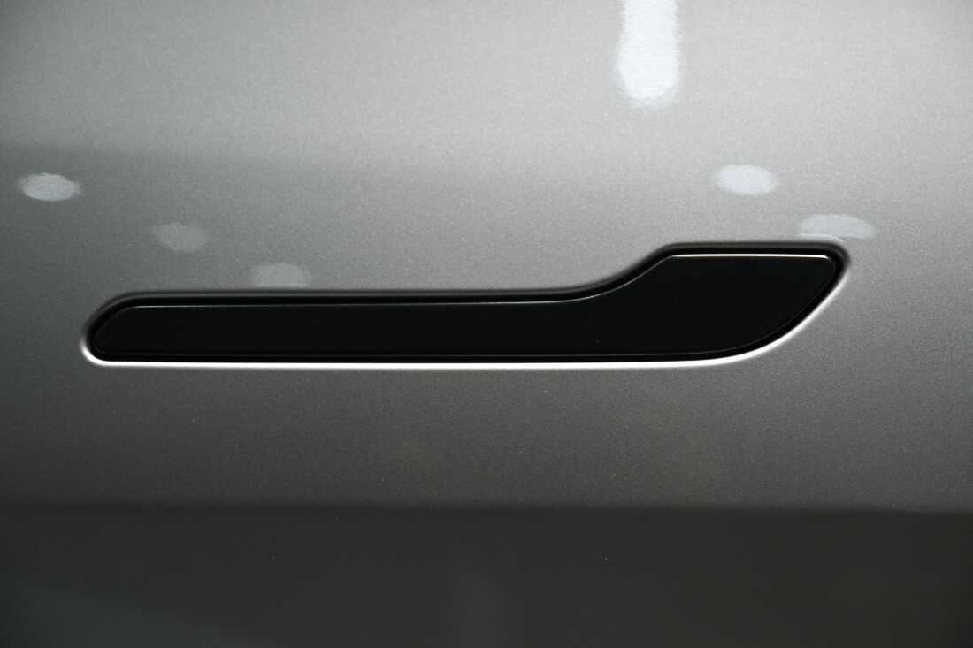The handle of a Tesla Model Y electric vehicle sits flush against the vehicle's side inside a showroom in Beijing on February 3, 2026. China will ban hidden door handles on cars sold in the country starting next year, phasing out the minimalist design because of safety concerns.