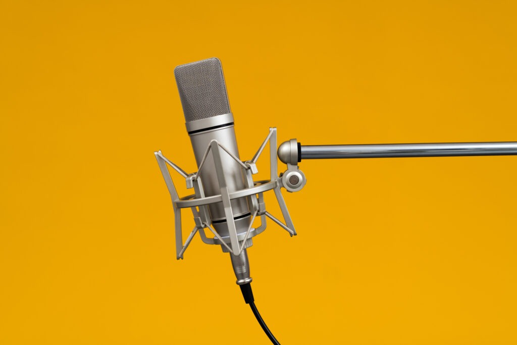 Condenser microphone on yellow background.