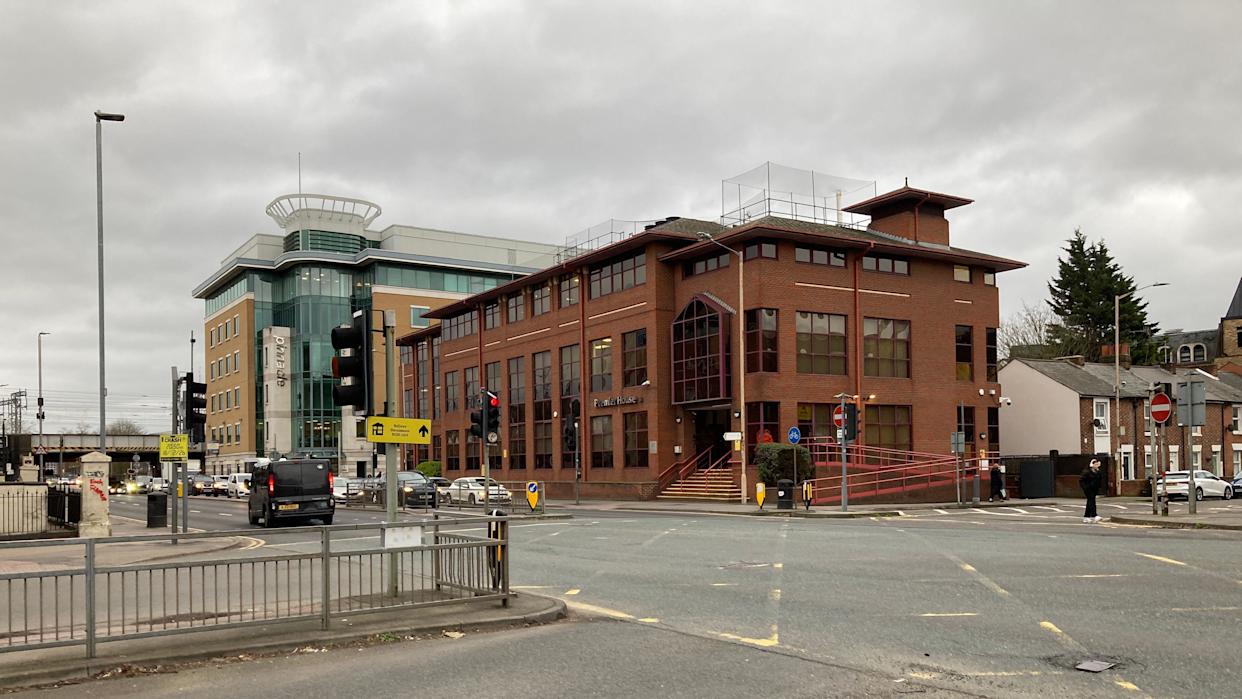 A general view on the corner of Caversham Road and Great Knollys Street with a brown brick building on the opposite corner can be seen