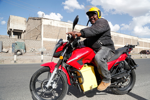 FILE -A man rides an electric motorcycle from Ampersand on a test drive in Nairobi, Kenya, Jan. 23, 2023. (AP Photo/Brian Inganga, File)