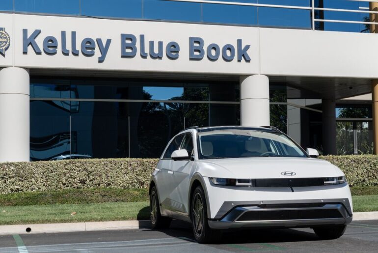 The 2026 Hyundai Ioniq 5 seen from a front quarter angle parked at a Kelley Blue Book office