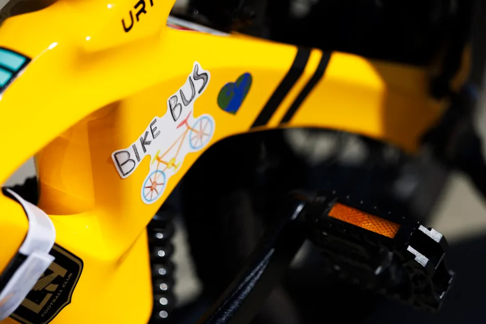 A sticker on a yellow bike reads, "bike bus."