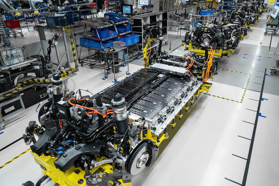 electric vehicle assembly line showcasing battery and chassis components