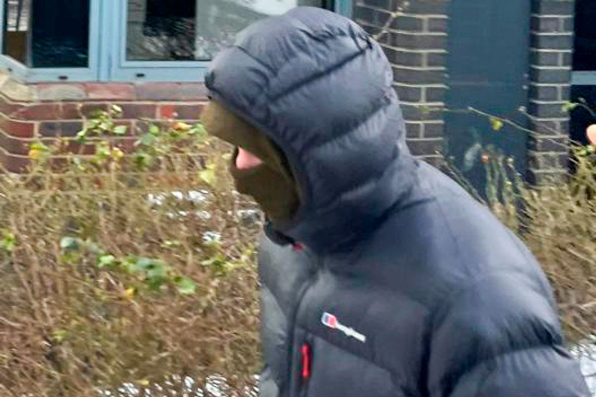 Billy Stokoe covers his face using a hood and scarf around the lower part of his face outside court