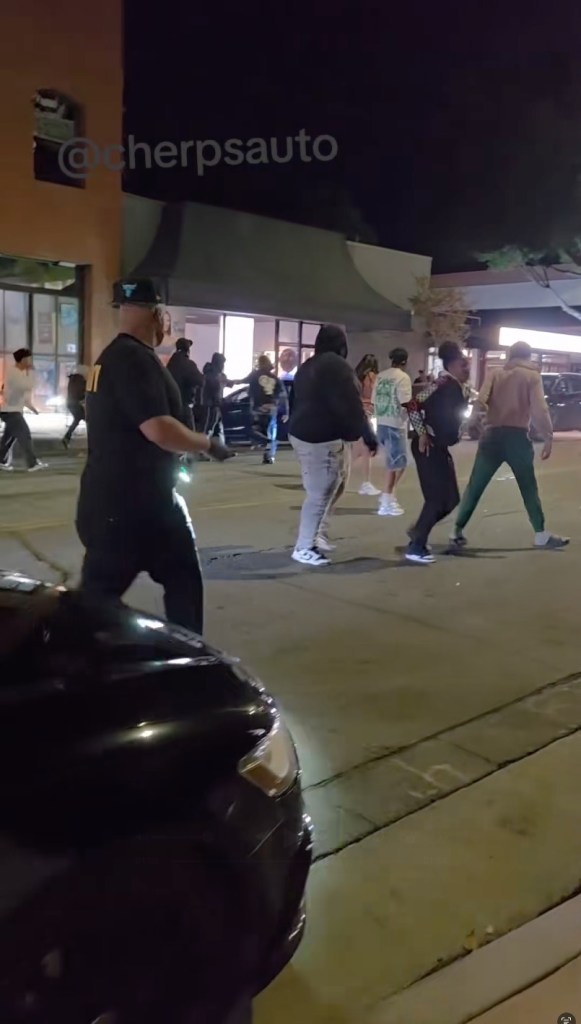 Authorities said one of the individuals involved got into a 2022 Tesla and drove away before circling back minutes later, "striking four people who were standing in the street in front of the bar."