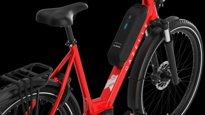 a red and black Gazelle e-bike on a black background.