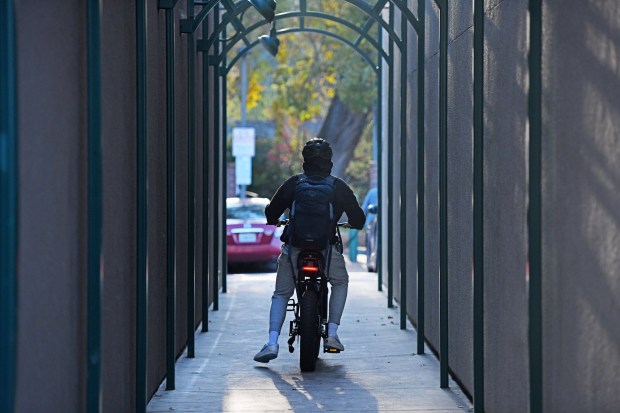 A bicyclist rides a motorized e-bike through a pedestrian walkway at a shopping center in Danville, Calif., on Thursday, Dec. 4, 2025. (Jose Carlos Fajardo/Bay Area News Group)
