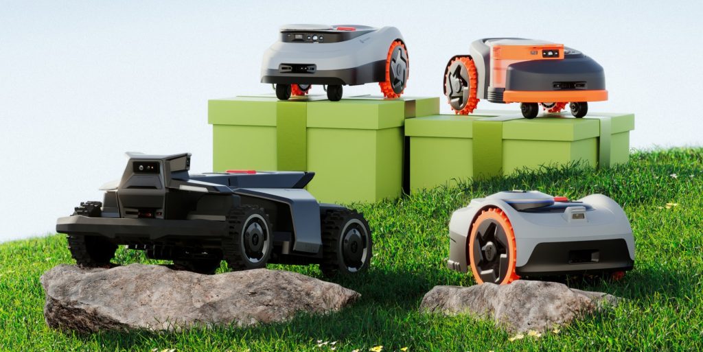 four Segway navimow robot lawn mowers sitting in grass and rocks