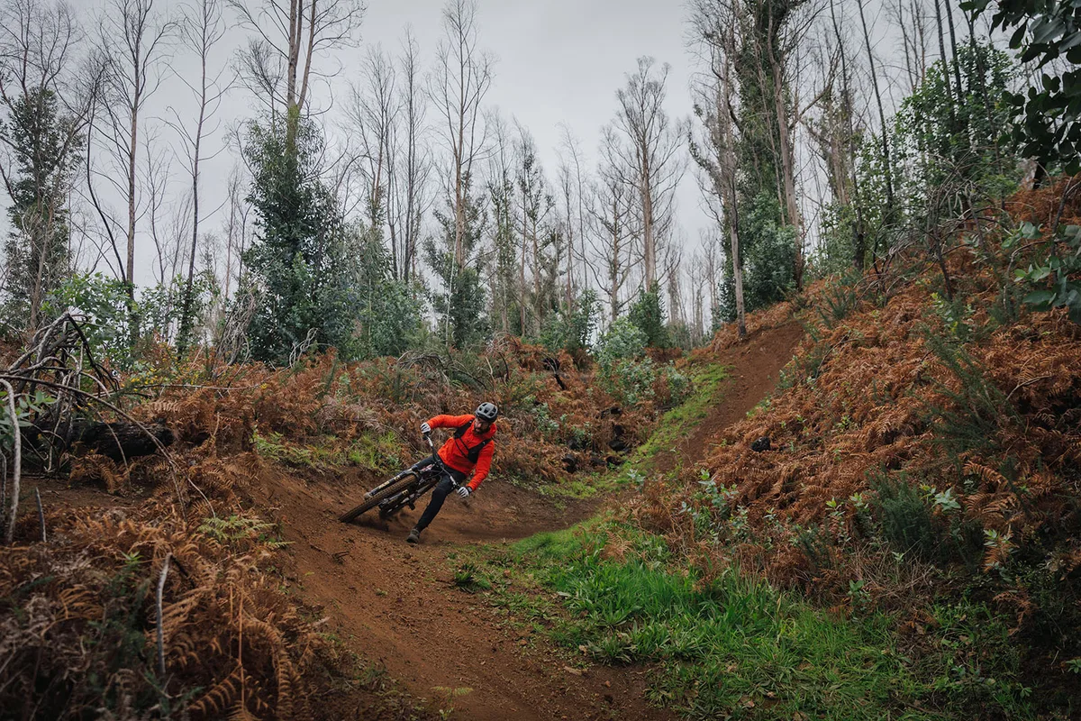 Male rider in orange jacket testing the Specialized S-Works Turbo Levo 4 full suspension mountaim eBike