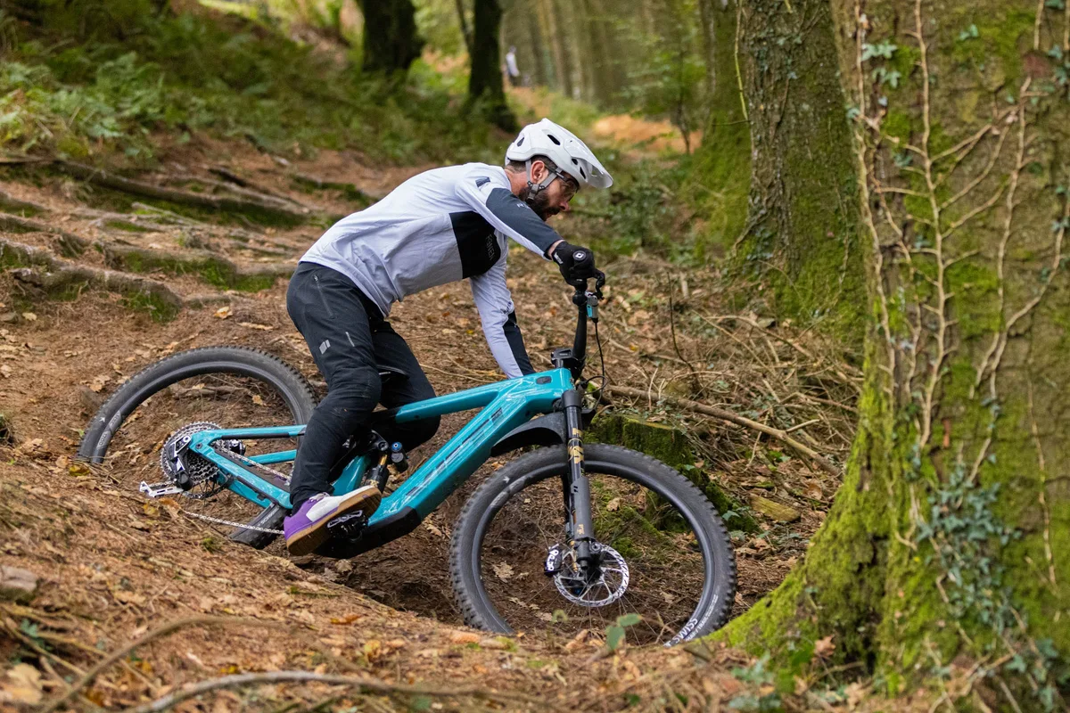 Rob Weaver cornering on the Yeti LTE T4 around a rooty turn.