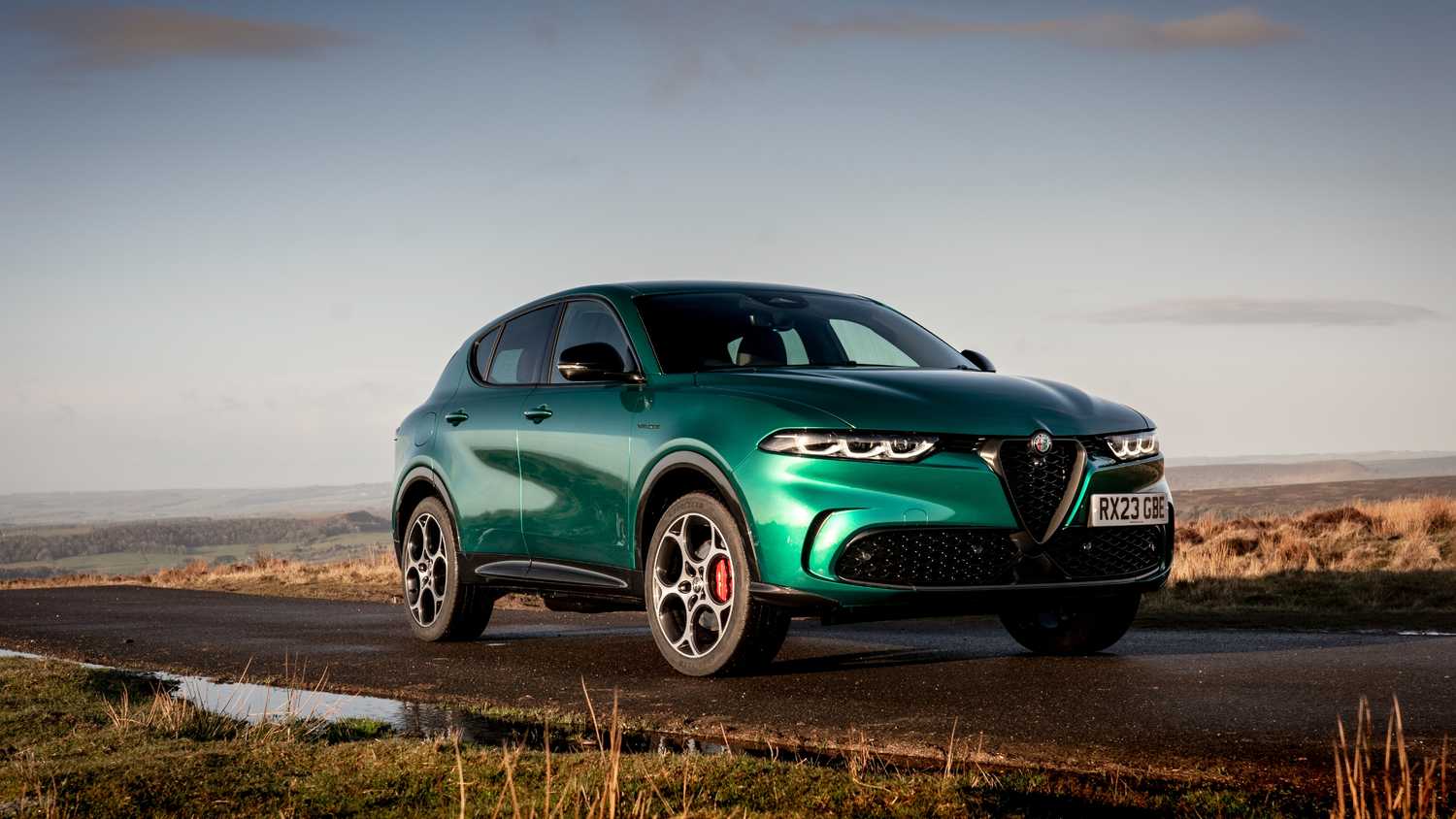 Front quarter view of the Alfa Romeo Tonale PHEV driving on road.