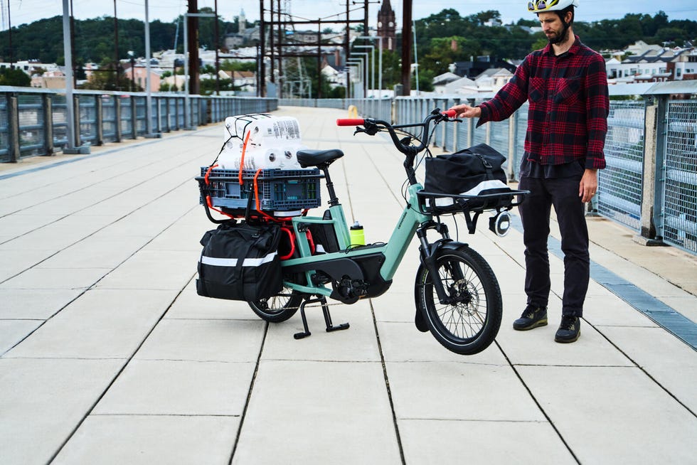 electric bike loaded with cargo and rider on a pedestrian path