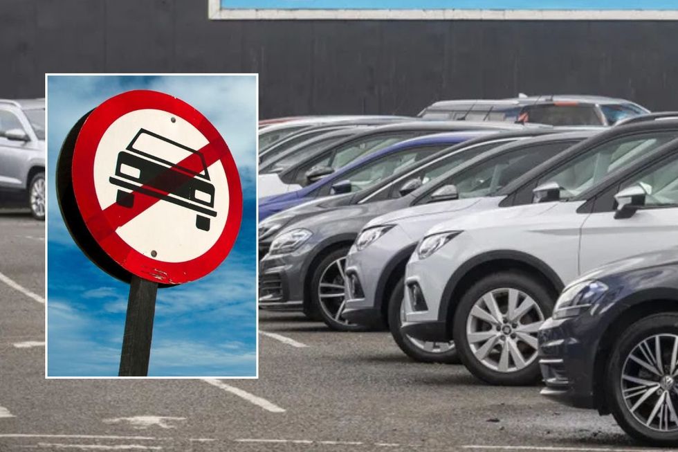 Car ban sign and vehicles parked