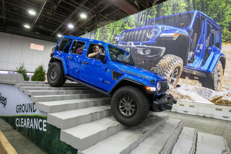 Bill Pugliano/Getty Images via CNN NewsourcePeople ride through an obstacle course in a Jeep Rubicon at the Jeep exhibit at the 2026 Detroit Auto Show on January 14