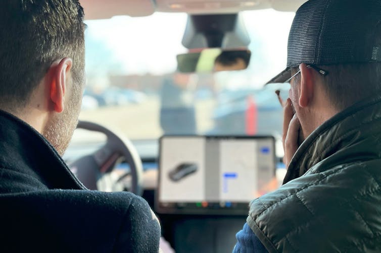 two men in electric car.
