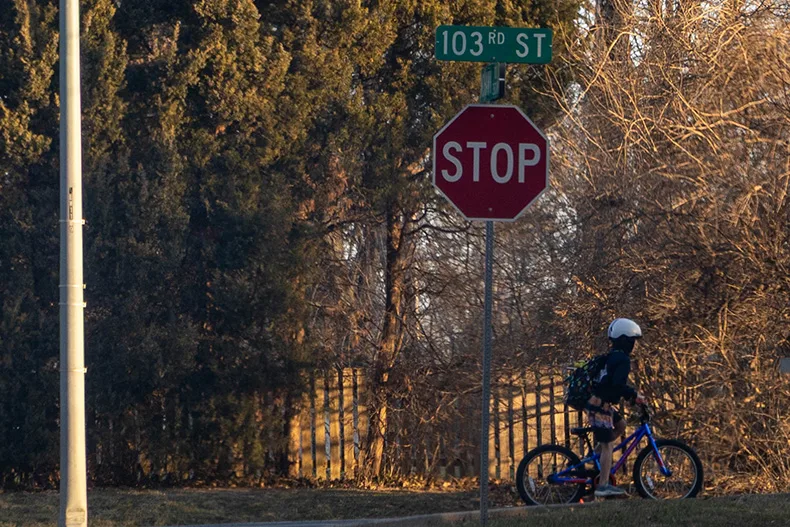 A cyclist wearing a helmt along 103rd Street on Wednesday morning.