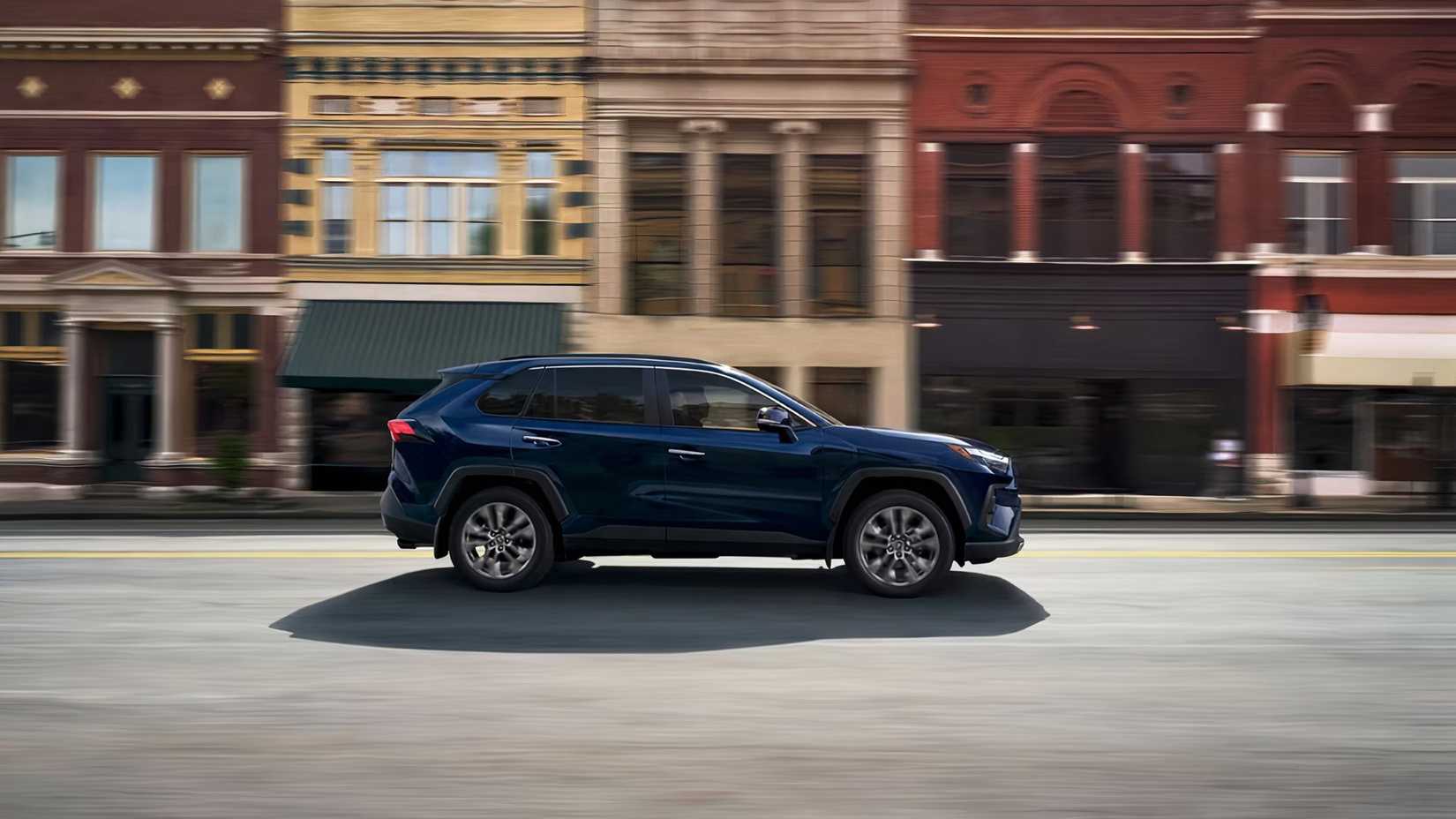 2025 Toyota RAV4 Plug-In Hybrid in blue being driven on road