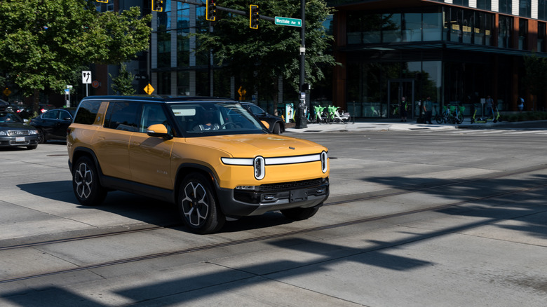 An electric Rivian R1S SUV in South Lake Union late in the day.