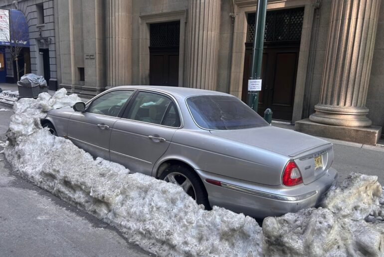 NYC winter street parked Jags - official cars of?