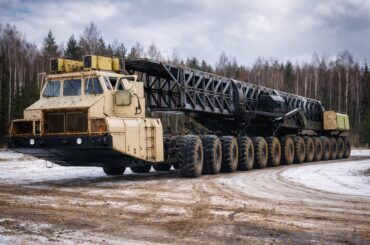 The MAZ-7907 is a 24-wheel drive (24x24) Soviet heavy transporter prototype, built in 1985 to carry ICBMs, featuring a hp gas turbine engine. It uses an electro-mechanical transmission with individual motors for each wheel, weighs roughly 66 tons, measures over 28 meters long, and has a 150-ton load