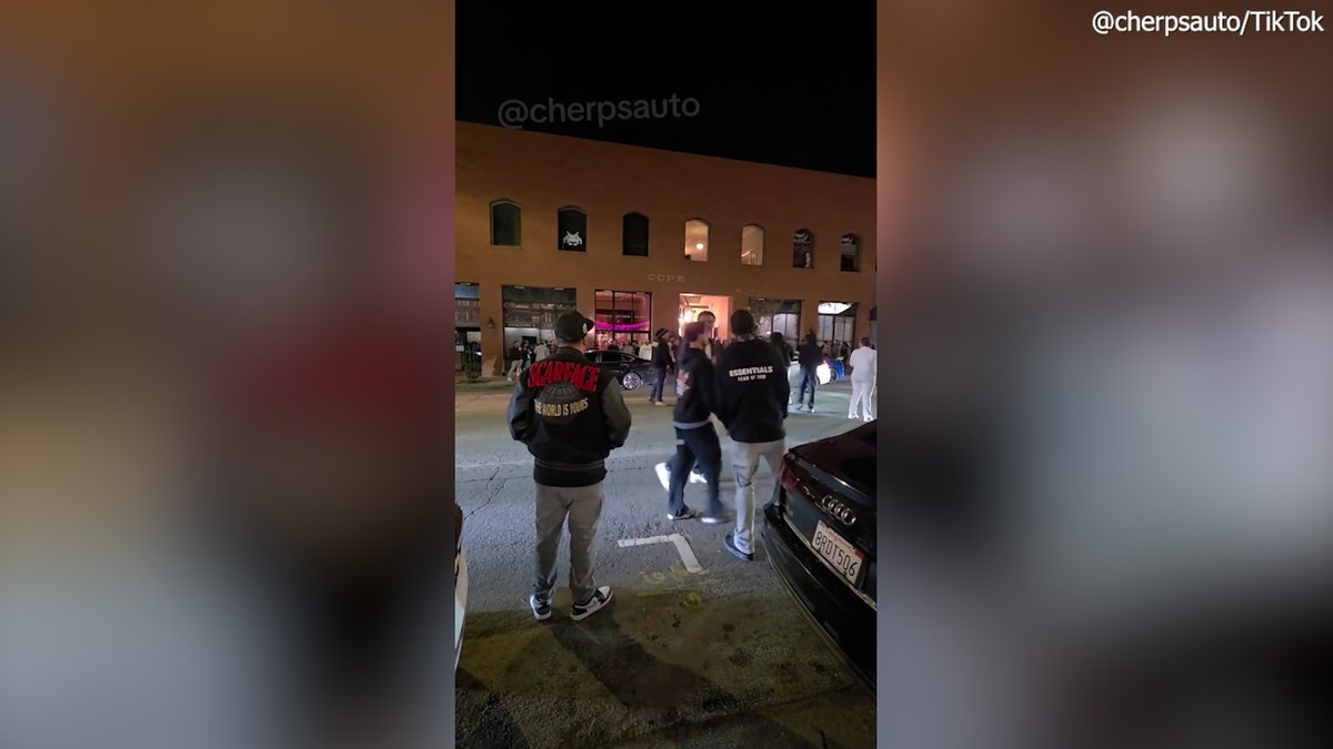 people gathering outside bar into street