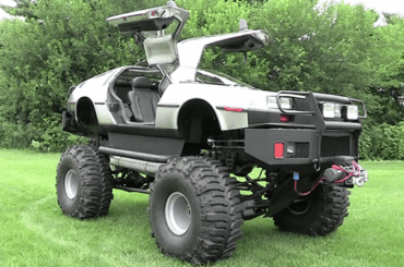 A photo of a DeLorean that was turned into a monster truck.