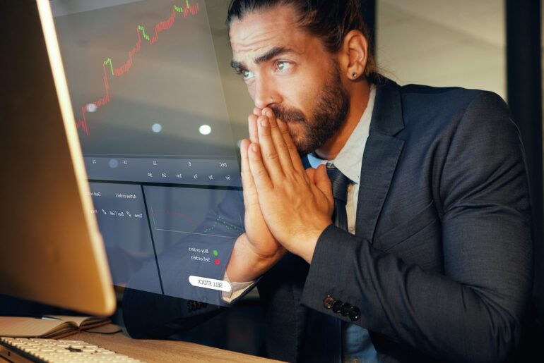 Serious man looking at a stock chart