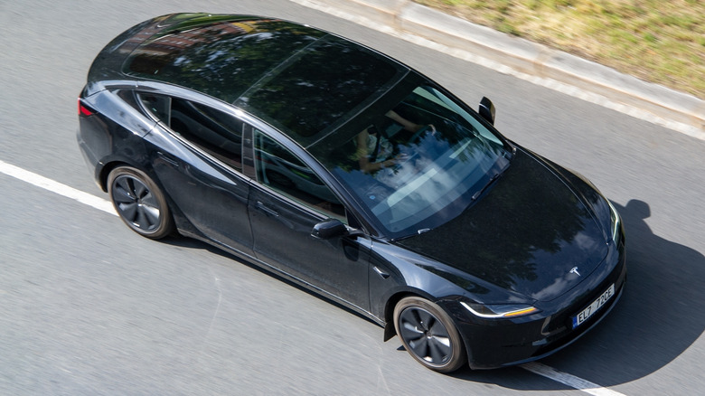 a Tesla Model 3 driving down a road