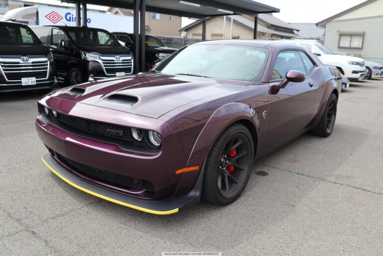 This brand-new 2025 Dodge Challenger Hellcat Redeye Jailbreak somehow ended up overseas… in Japan. It has 76 miles, and even still has the Dealership guards. How do you think it got there? Come up with a story.