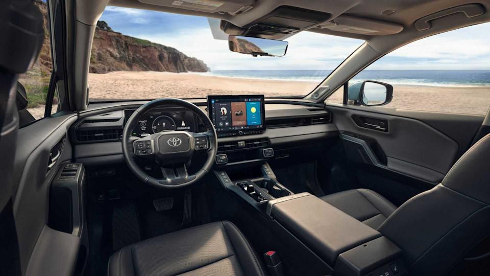 Shot of the cabin of the 2026 Toyota RAV4 Limited showing the front seats, steering wheel, and infotainment screen.