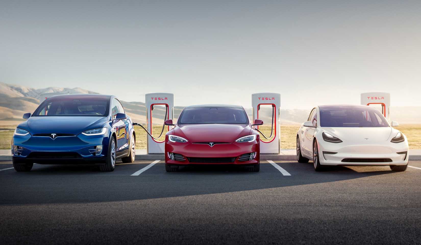 Tesla Model S, Model X, and Model 3 parked outdoors and charging