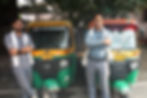 Two auto-rickshaws parked side by side. Their owners stand in front, posing for the camera. One auto bears the name of YouTuber The Abhilak Singh.