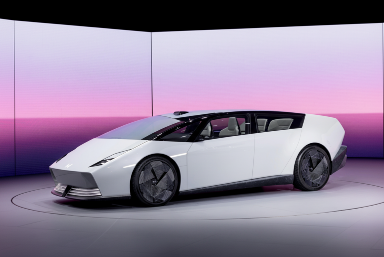 A white, futuristic car with a sleek design and dark tinted windows, displayed on a circular platform with a pink and purple gradient background.