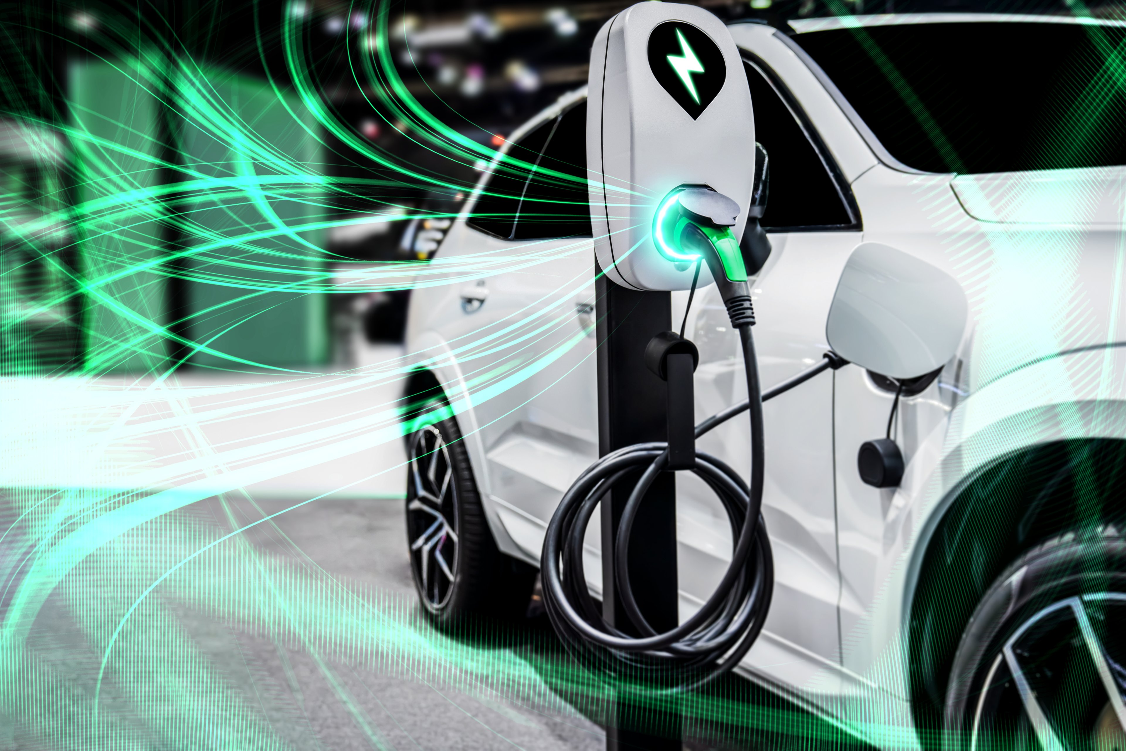 An electric vehicle is charging. The electricity is visible and depicted as green waves traveling to and from the stationary charger.