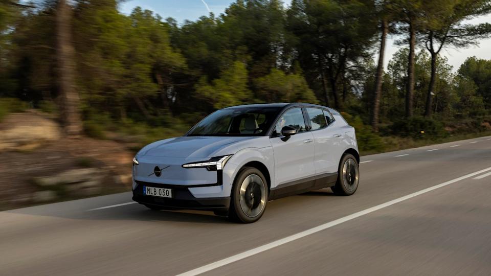 A grey 2025 Volvo EX30 on a forest road.