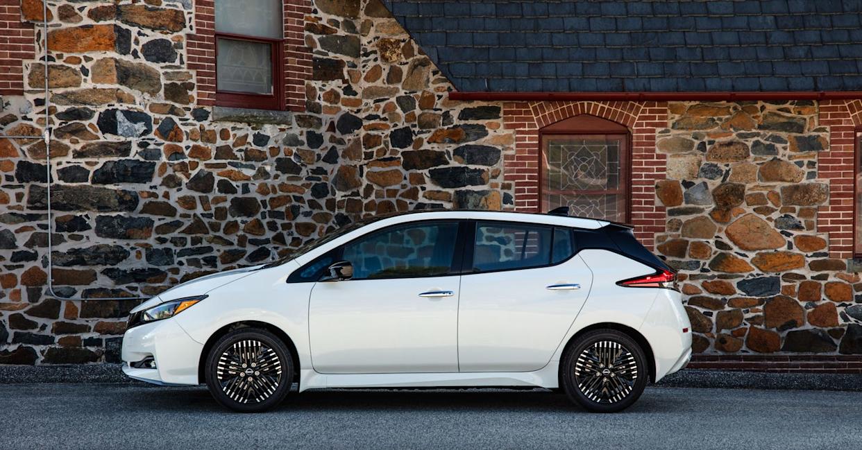 nissan leaf profile shot against stone and brick home