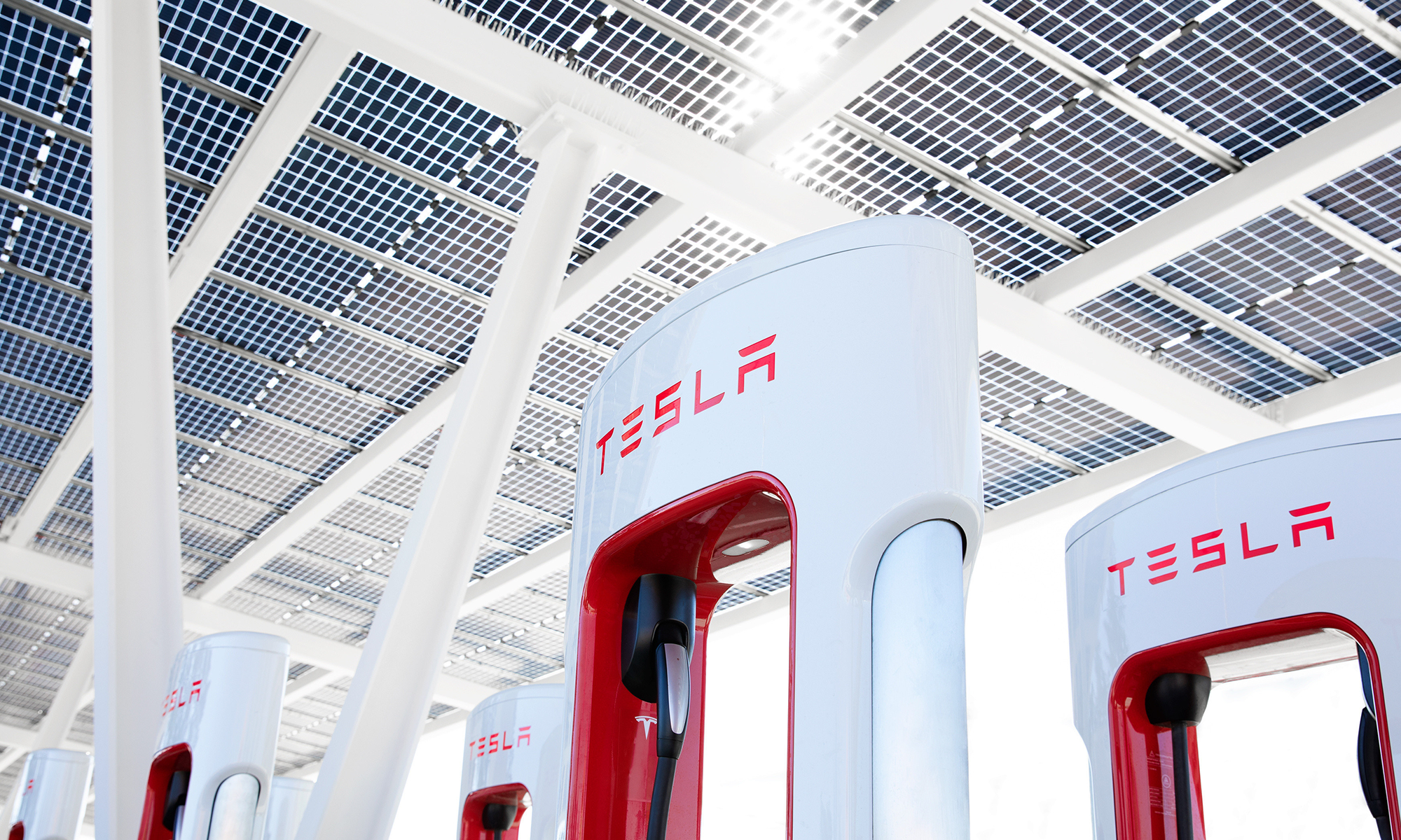 Tesla charging stations under a solar roof.