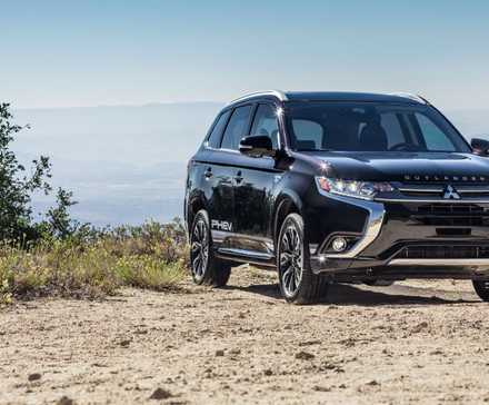 Front view of black 2018 Mitsubishi Outlander PHEV parked on gravel.